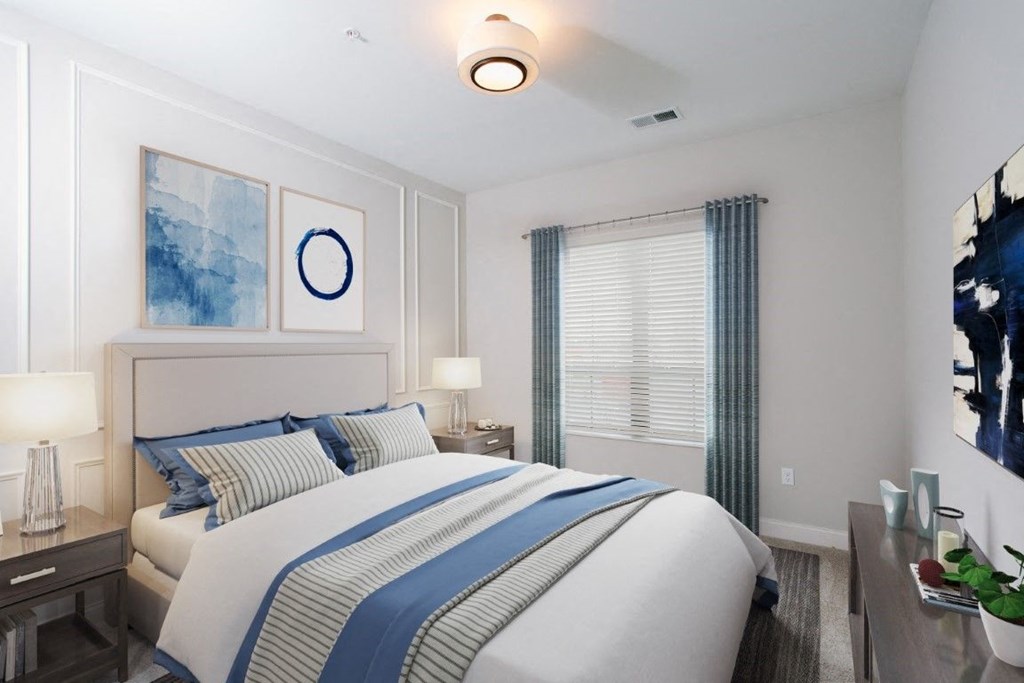 a bedroom with a large bed and two night stands with lamps at Fairfax, Grandview, OH