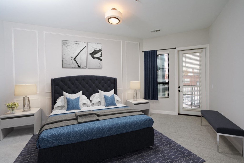 a bedroom with a bed and a door leading to a balcony at Fairfax, Grandview, OH, 43212
