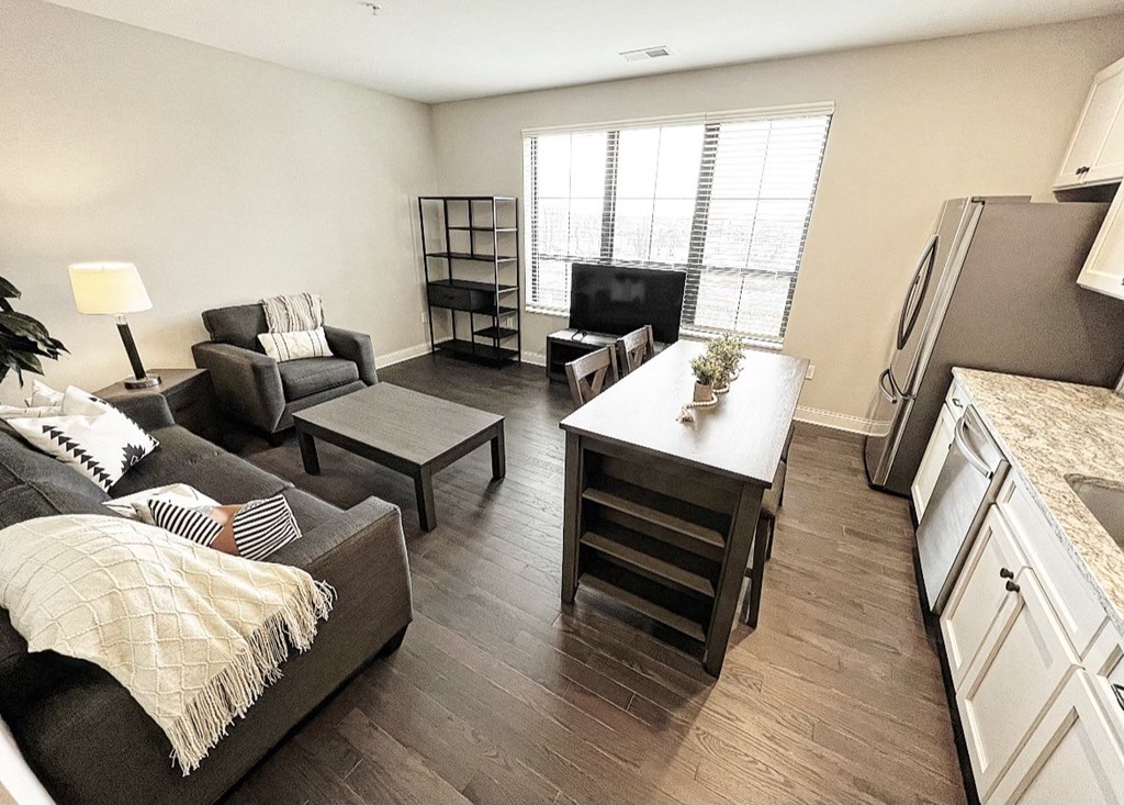 a living room with a couch a table and a television at Fairfax, Grandview, OH