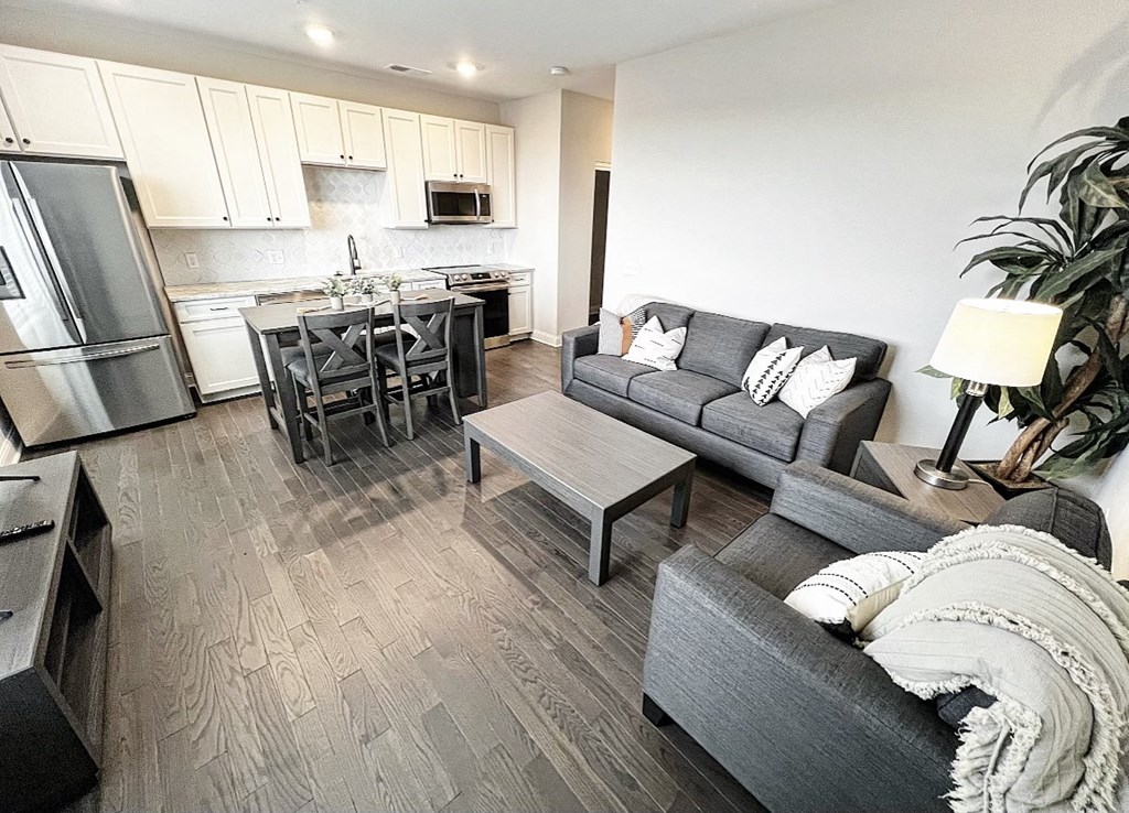a living room with couches a coffee table and a kitchen in the background at Fairfax, Grandview, OH, 43212