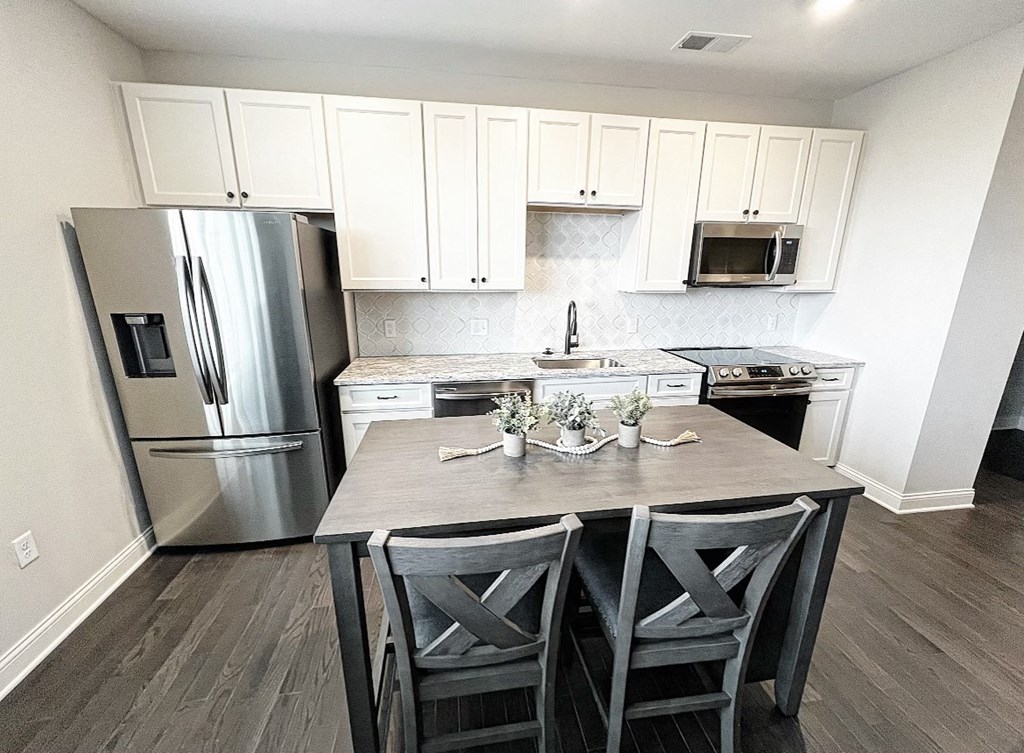 a kitchen with white cabinets and stainless steel appliances at Fairfax, Grandview, OH, 43212