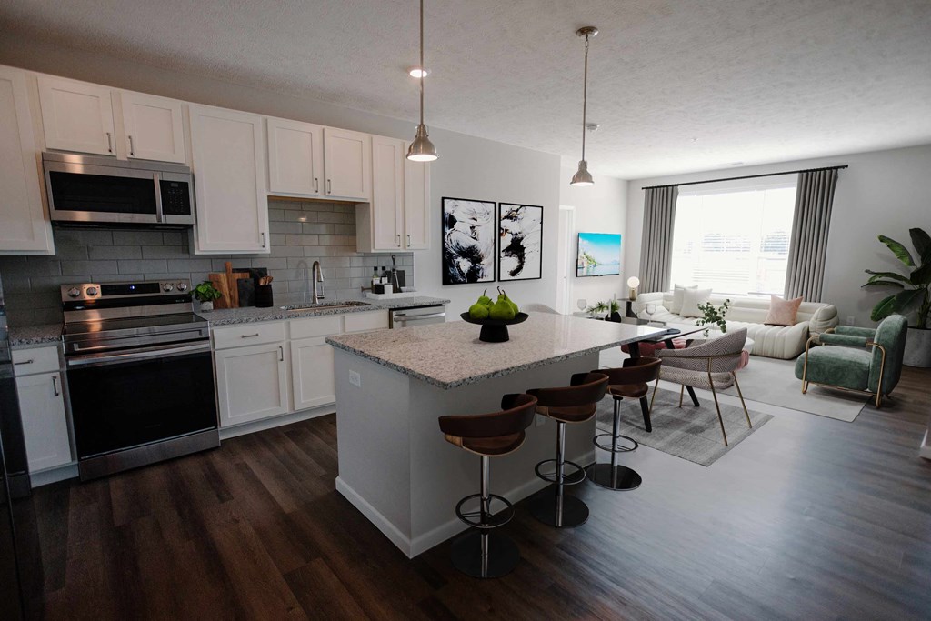 a kitchen and living room with a table and chairs at Kendall Park Too, Ohio