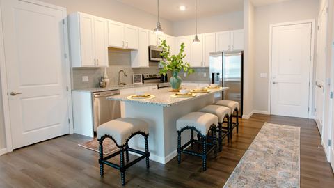 a kitchen with white cabinets and a large island with a granite countertop at Kendall Park Too, Columbus, 43220