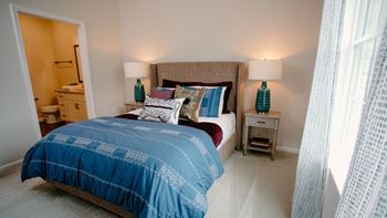 a bedroom with a bed and two night stands with lamps at Dalton, New Albany, 43081