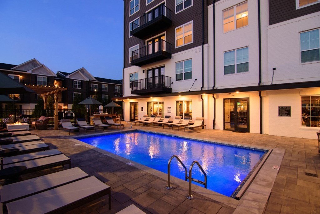 a swimming pool at night in front of an apartment building at Kendall Park, Columbus, OH, 43220