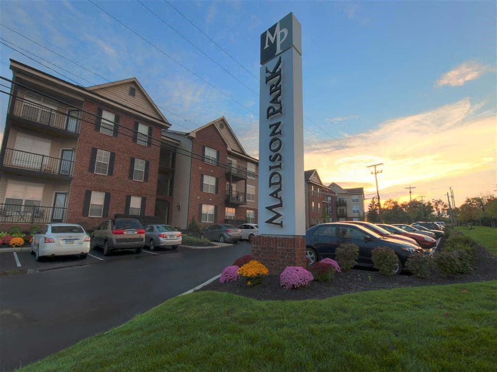 A sign for apartment buildings with the name
