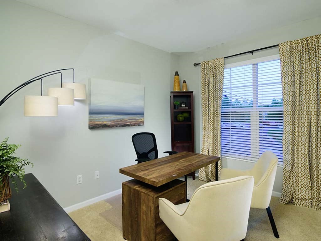 A dining room with a wooden table and chairs.