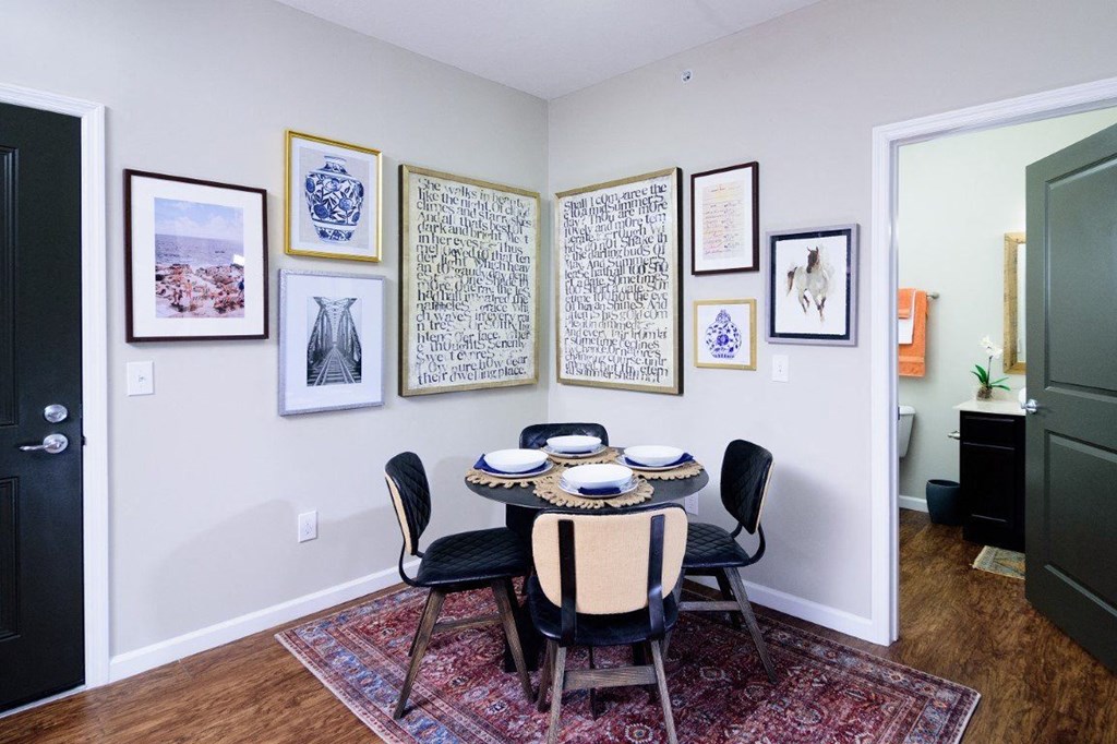 a dining room with a table and chairs and pictures on the wall at Taylor House Apartments, Columbus, Ohio