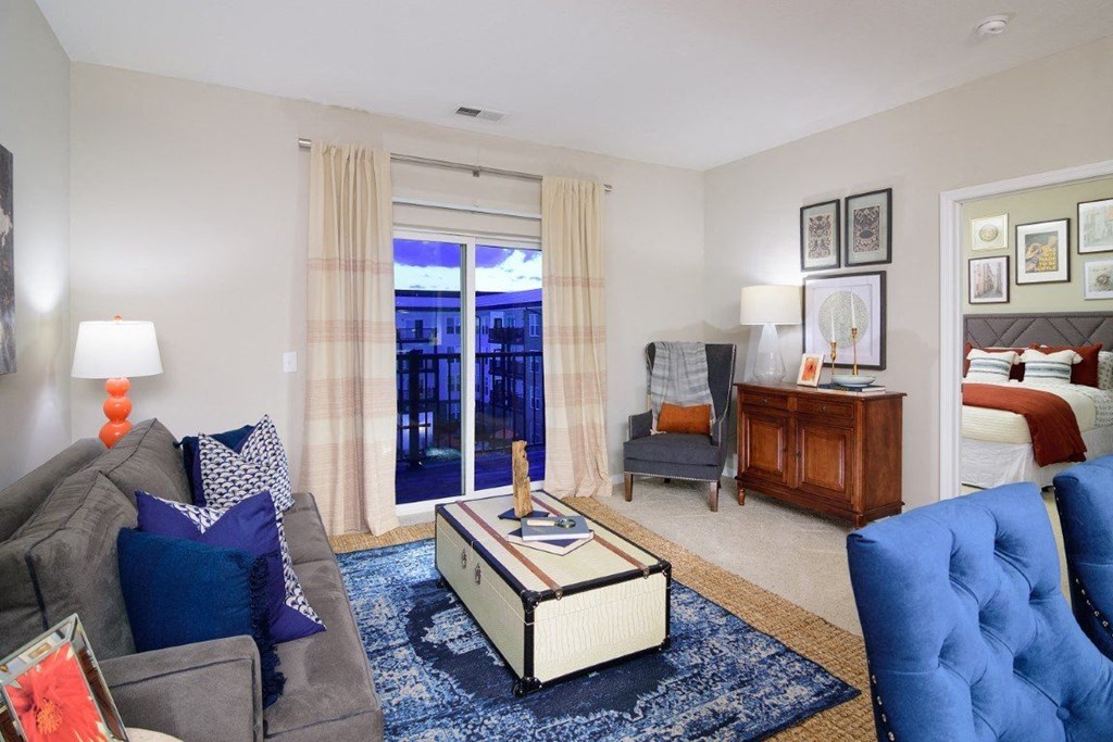 a living room with a couch and a chair and a bedroom with a bed at Taylor House, Columbus, OH