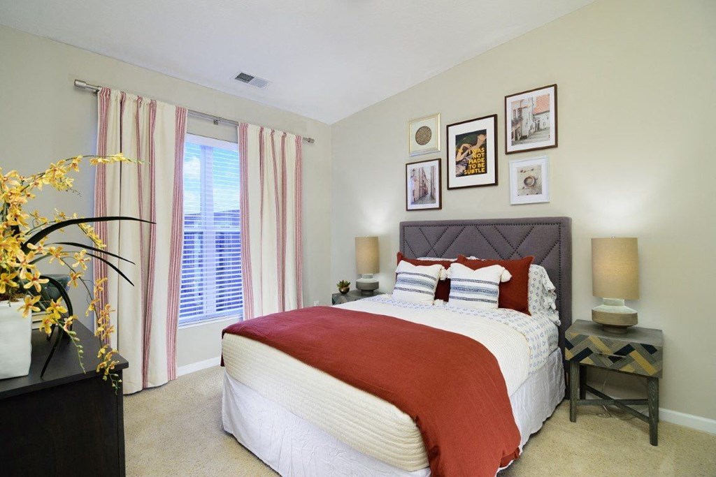 a bedroom with a bed and some pictures on the wall at Taylor House, Columbus, 43214