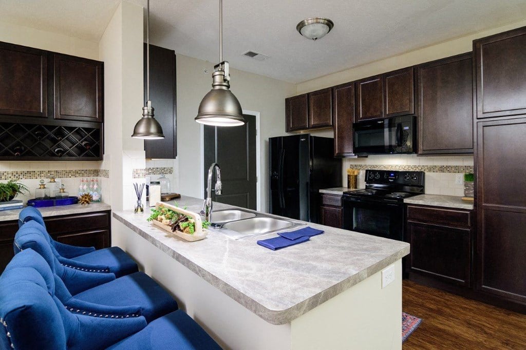 a kitchen with black appliances and a white counter top a kitchen with black appliances and a white counter top at Taylor House, Columbus, 43214