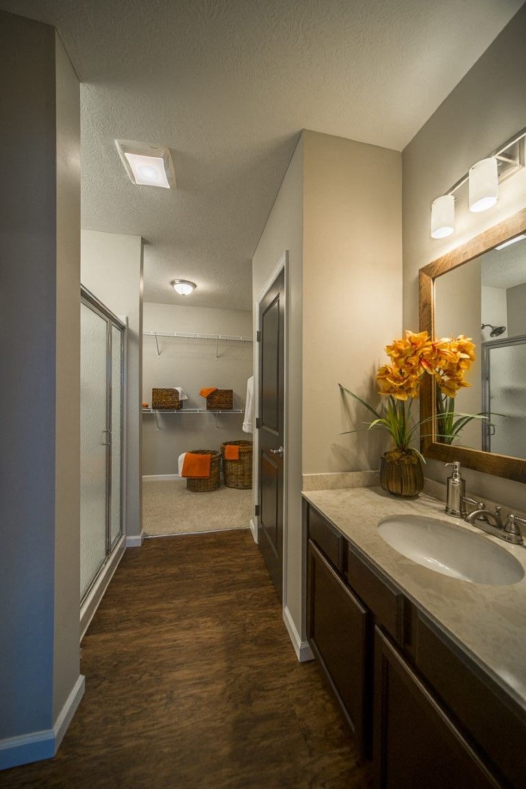 a bathroom with a sink and a shower and a mirrorat Taylor House Apartments, Columbus, OH