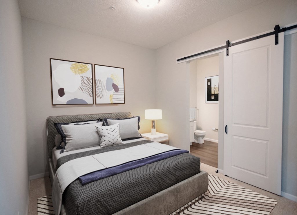 a bedroom with a bed and a sliding door to the bathroom at Kendall Park Too, Columbus Ohio