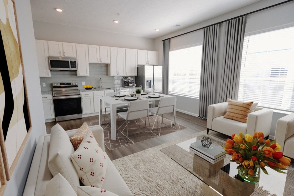 a living room and kitchen with a table and chairs at Kendall Park Too, Columbus, OH