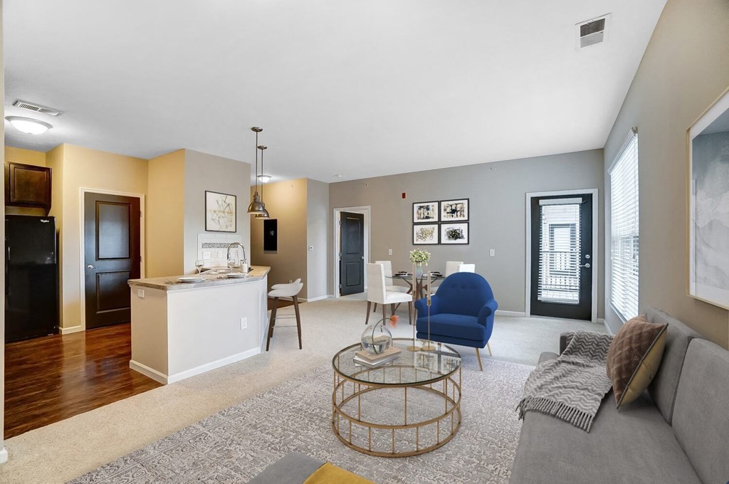a living room and kitchen with a couch and a tableat Taylor House Apartments, Columbus, Ohio