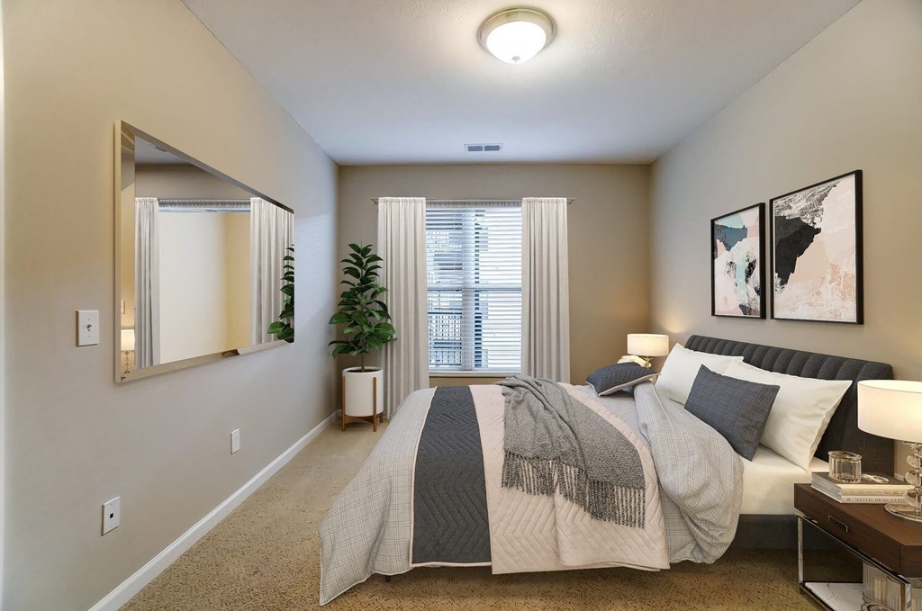 a bedroom with a bed and a mirrorat Taylor House Apartments, Columbus, OH, 43214