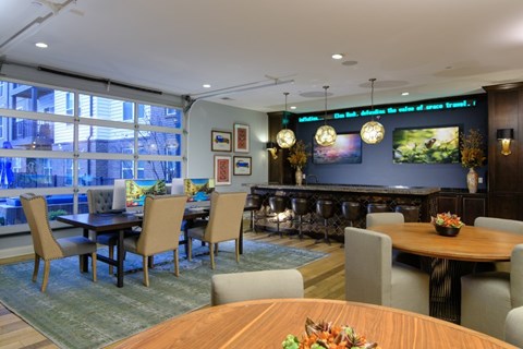 A dining room with a table set for a meal.