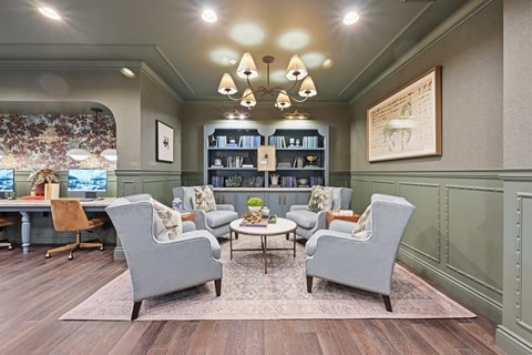 A living room with grey chairs and a coffee table.
