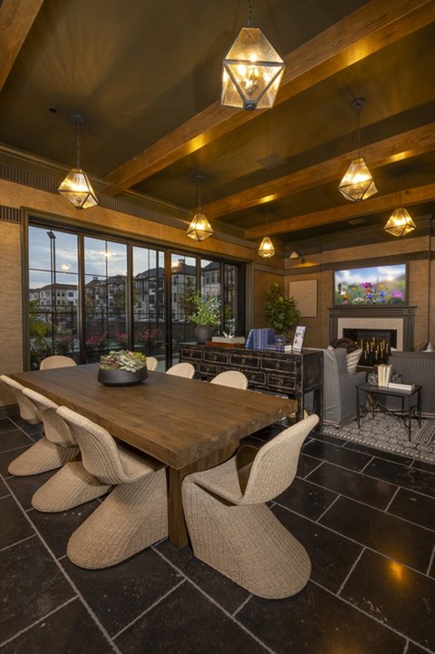 A modern dining room with a wooden table and chairs.