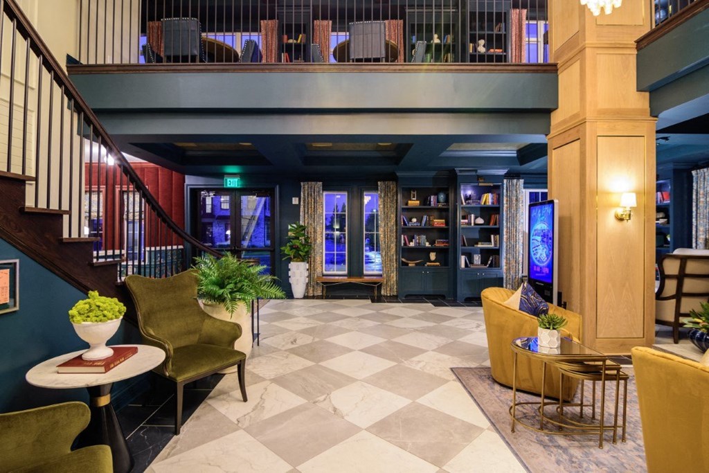 a lobby of a hotel with a staircase and a book shelf at Dalton, New Albany, 43081
