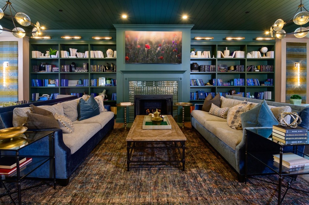 A living room with a fireplace and a bookshelf.
