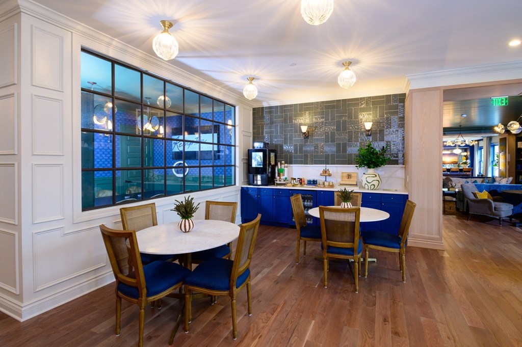 A dining room with a table set for four.