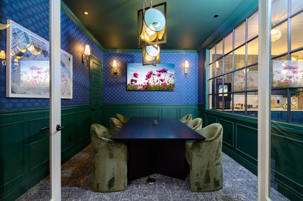 A dining room with a table and chairs.