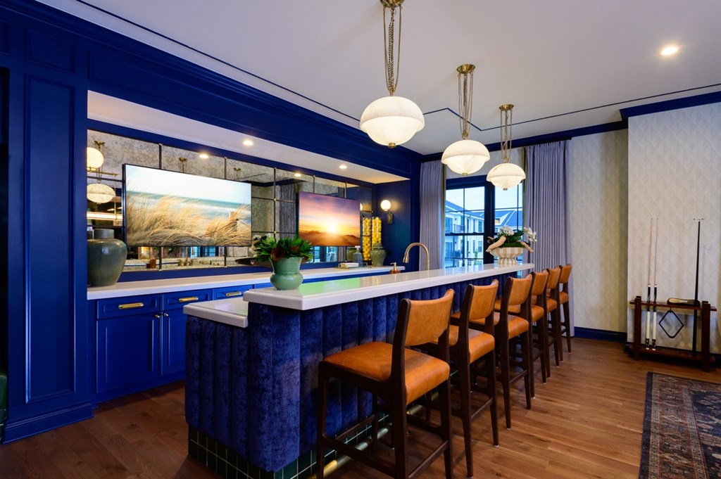 A kitchen with blue cabinets and a white countertop.