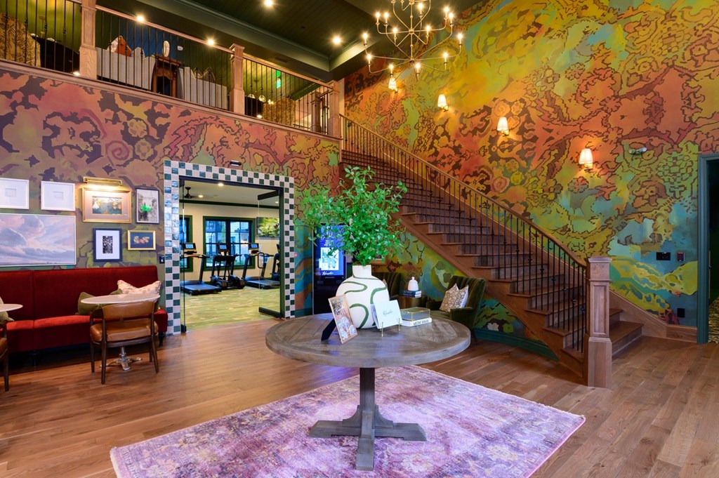 A living room with a staircase and a couch.