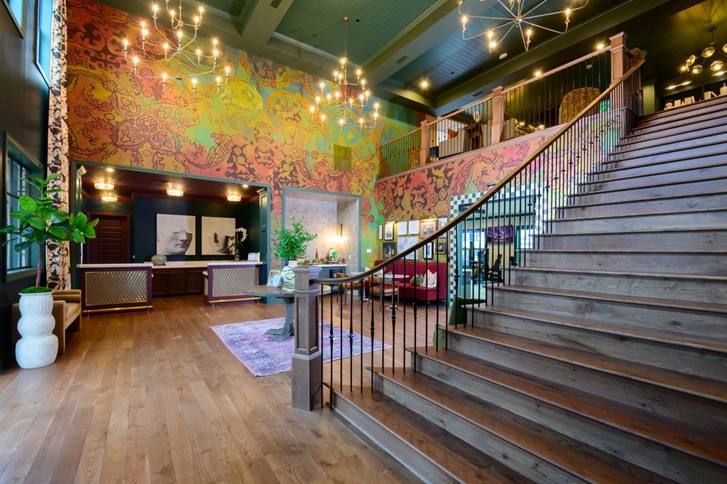 A staircase with a metal railing leads up to a second floor.