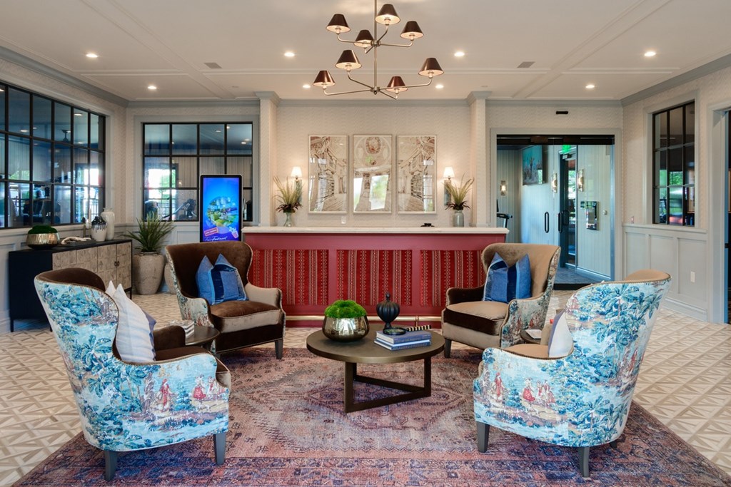A living room with a sofa, two chairs and a coffee table.