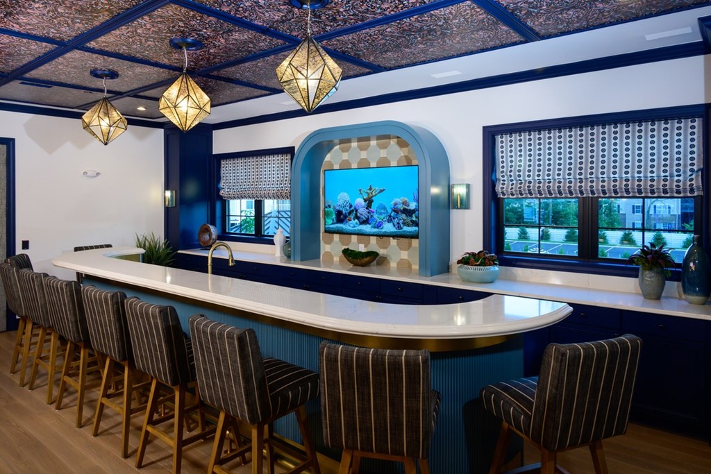 A bar with a blue and white color scheme and a large window.