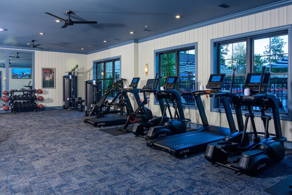 A gym with treadmills and exercise bikes.