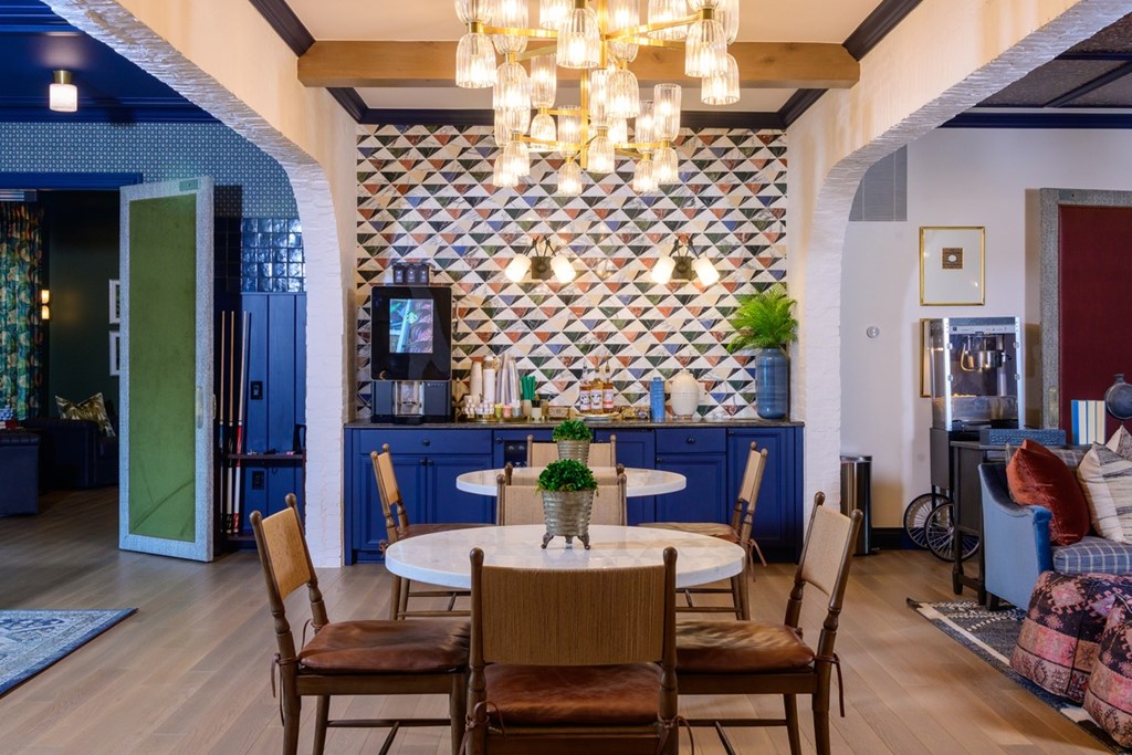 A dining room with a table set for four.