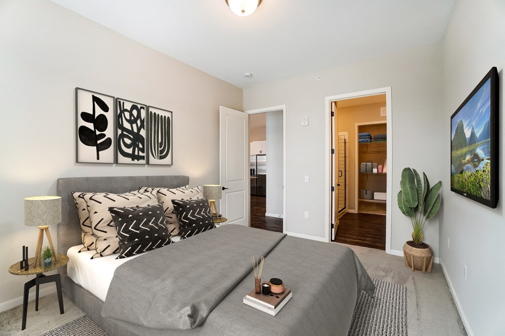 a bedroom with a bed and a door to a bathroom at Essex, Columbus, 43212