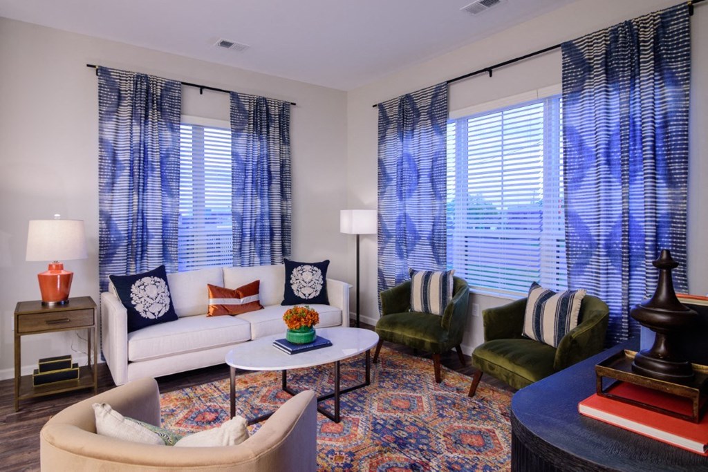 a living room with couches chairs and a table at Essex, Columbus