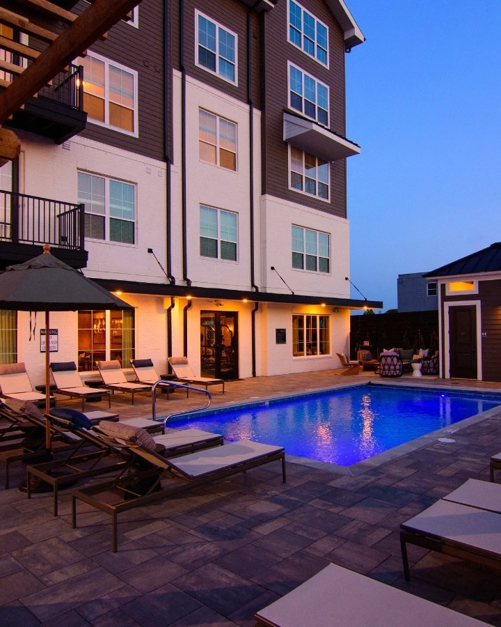 a swimming pool in front of a building at night at Kendall Park, Columbus, OH, 43220