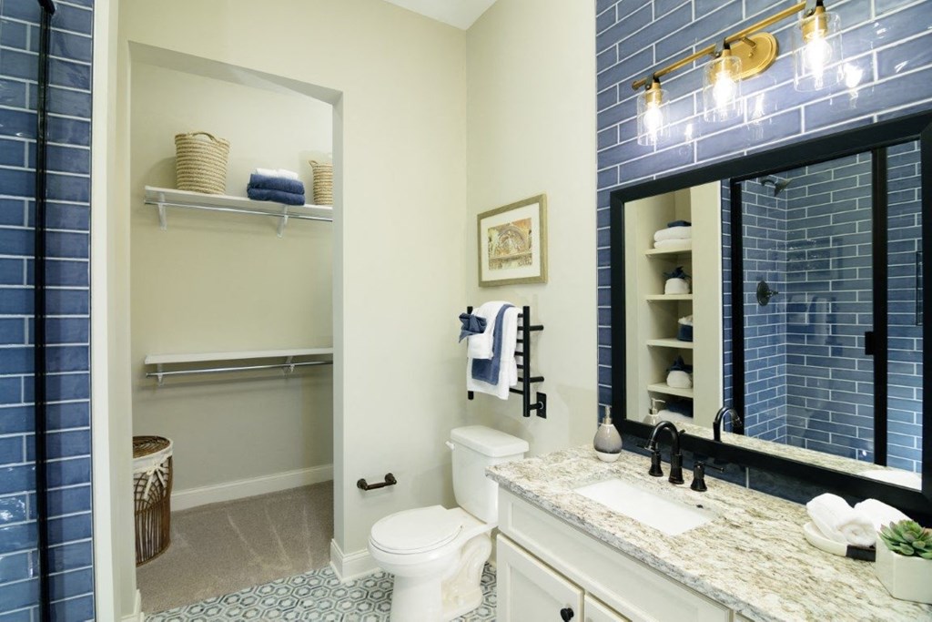 a bathroom with blue tile and a white toilet at Fairfax, Ohio