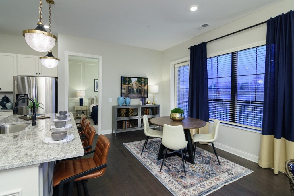 a kitchen and dining room area with a table and chairs and a large window at Fairfax, Grandview, 43212