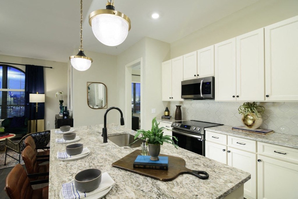 a kitchen with white cabinets and granite countertops at Fairfax, Grandview, OH, 43212