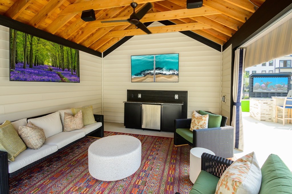 A living room with a white couch and a fireplace.