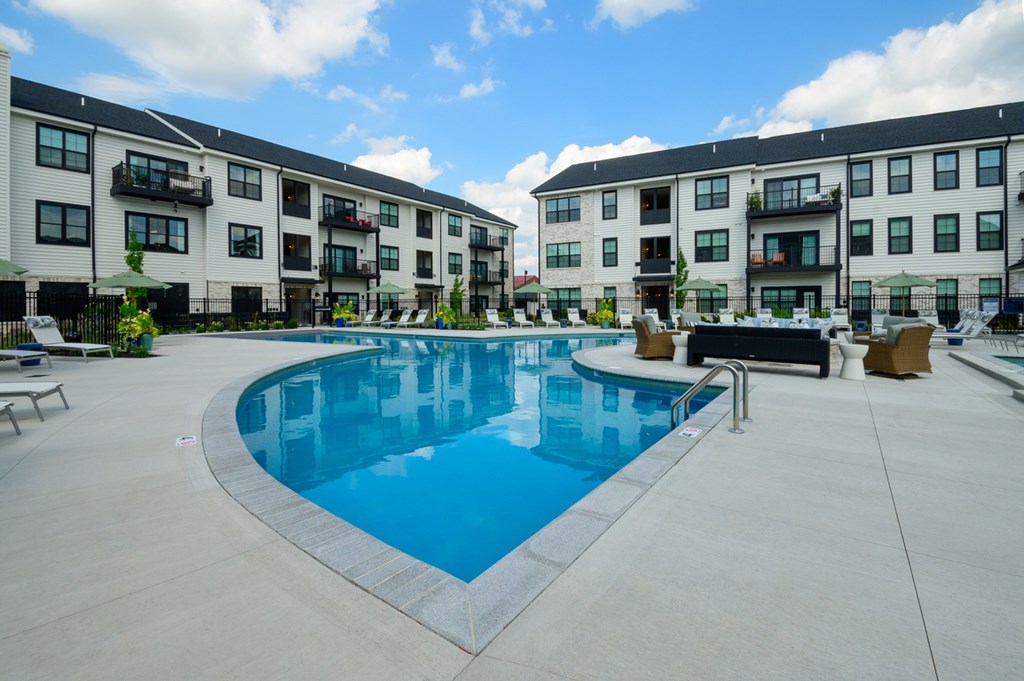A swimming pool in front of apartment buildings.