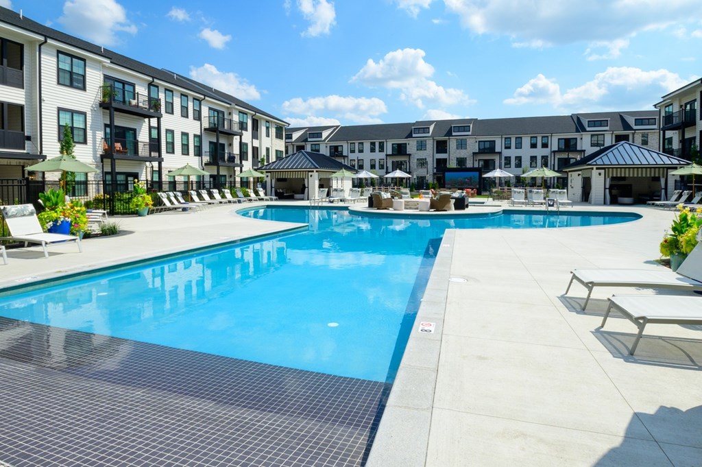 A large swimming pool surrounded by apartment buildings.