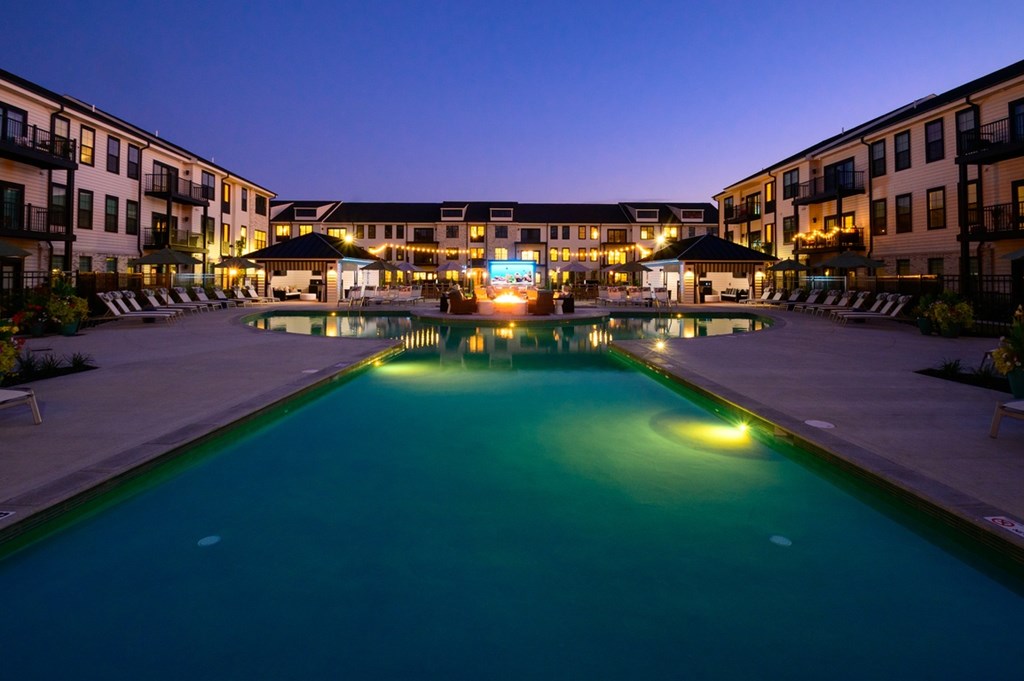 A swimming pool in a resort at night.