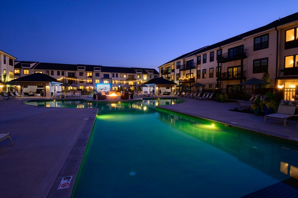 A swimming pool in a resort at dusk.