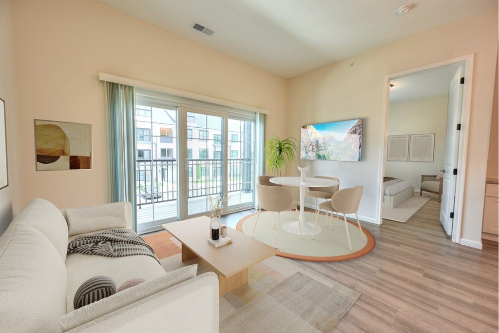 A living room with a white couch and a coffee table.