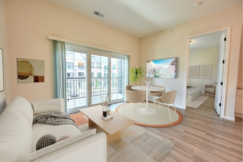 A living room with a white couch and a coffee table.