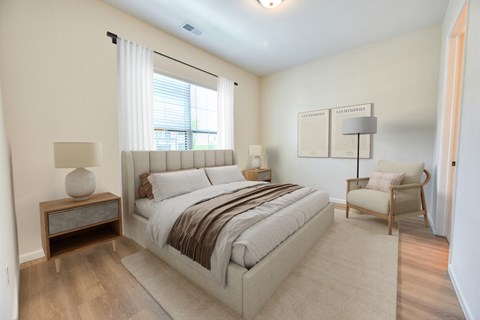 Bedroom with upholstered bed and neutral decor at Kempton Apartments, Columbus, Ohio