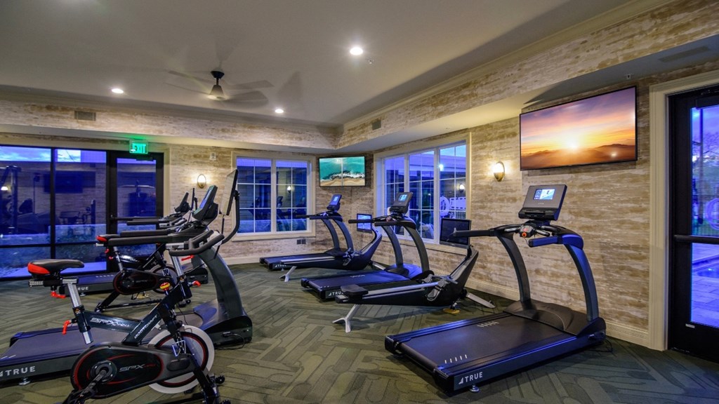 a gym with exercise machines and a tv on the wall at Kendall Park Too, Ohio
