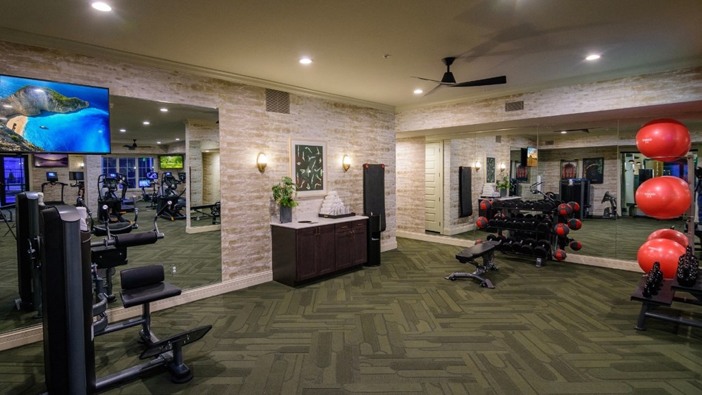 a gym with a lot of weights and a tv at Kendall Park Too, Ohio, 43220